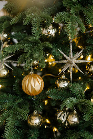 Christmas background with illuminated Christmas tree, Golden toys and lights
