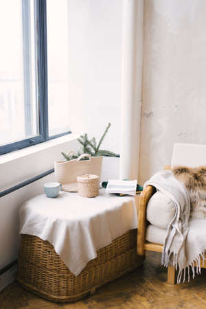 Part of the living room in the Scandinavian style, decorated for Christmas or New Year. Pine branches in a wicker bagの写真素材