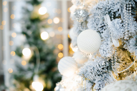 Elegant beautiful silver Christmas tree with white and gold balloons close up. Background for copy spaceの写真素材