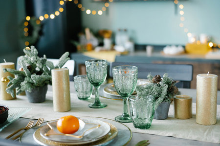 Beautiful table setting with Christmas decorations in living roomの写真素材