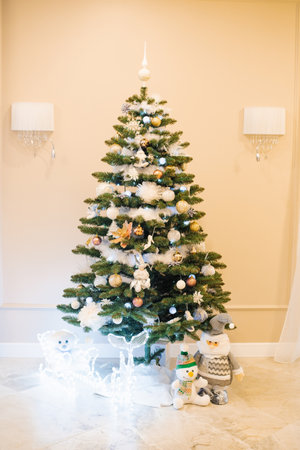 Beautiful Christmas tree with toys and lights in the living roomの写真素材