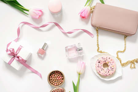 Valentine's Day, Mother Day, spring Concept with bag, donut, tulip pink and cosmetics. Top view. The view from the top. Trending concept for a bloggerの写真素材