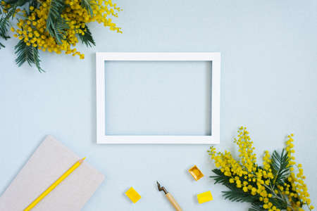 Blank paper, ink pen, yellow watercolor, mimosa flowers text frame. Copy the place for the wedding inscription or greeting card. Copy space for a calligrapher, artist, or bloggerの写真素材