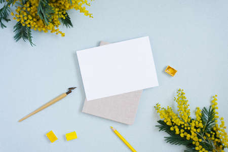 Plain paper, ink stick, yellow, watercolor, flowers of Mimosa. Copy the place for the wedding inscription or greeting card. Copy space for the calligrapherの写真素材