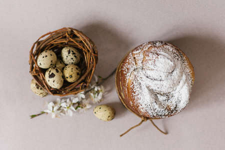 Beautiful Easter composition with quail eggs, Easter cake, the cherry blossoms are traditionally...