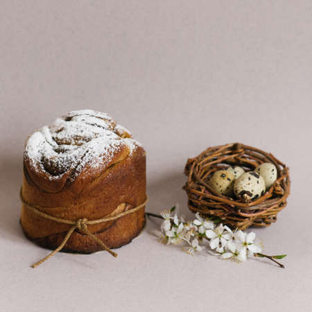 Beautiful Easter composition with quail eggs, Easter cake, the cherry blossoms are traditionally...