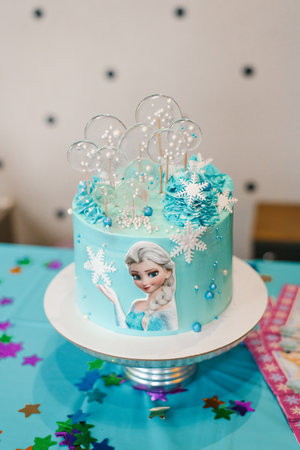 Moscow, Russia. May 2021. Children's birthday cake in the style of a Frozen heart with Elsaのeditorial素材