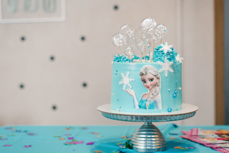 Moscow, Russia. May 2021. Children's birthday cake in the style of a Frozen heart with Elsa