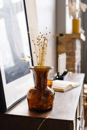 Brown glass vase with dried flowers in the interior of a modern houseの写真素材