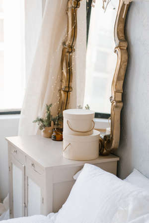 Mirror over the chest of drawers in the interior of the bedroom, decorated for Christmas in the Scandinavian styleの写真素材