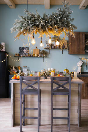 Christmas decor in the kitchen. Christmas kitchen utensils. Bright interior of the new year's kitchen. The Kitchen Is Mint Blue.の写真素材