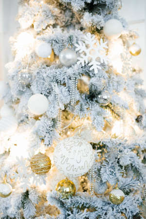 Elegant beautiful silver Christmas tree with white and gold balloons close up. Background for copy spaceの写真素材