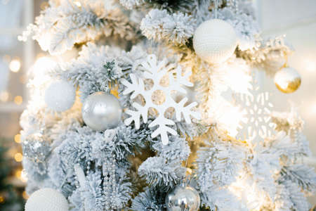 Elegant beautiful silver Christmas tree with white and gold balloons close up. Background for copy spaceの写真素材