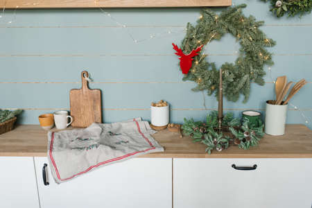 Rustic kitchen with wooden walls and Christmas decorations and dishesの写真素材