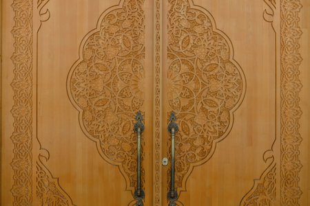 Tashkent, Uzbekistan. December 2020. Wooden carved doors of the White Mosque Minorのeditorial素材