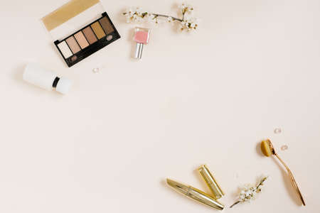 woman background. Spring flowers and woman cosmetic on beige background. Flat lay, top view.の写真素材