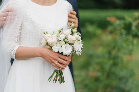 Details of the wedding morning. Wedding bouquet in the hands of the brideの写真素材