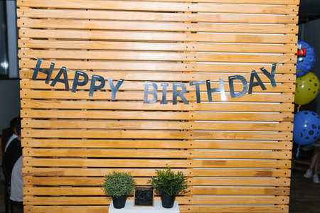 The inscription "Happy birthday" on the wooden wall. Photo zone for the holidayの写真素材