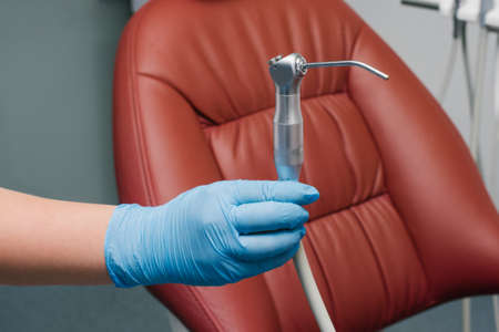 A water-air gun from the installation of a dental chair in the hands of a doctorの写真素材