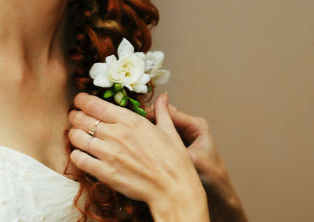 The bride is braided and decorated with white freesia flowersの写真素材