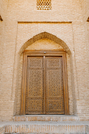 Bukhara, Uzbekistan. March 2022. Carved wooden door in oriental motifs