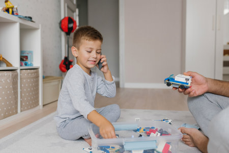 Baby boy playing with toys on the floor in the nursery
