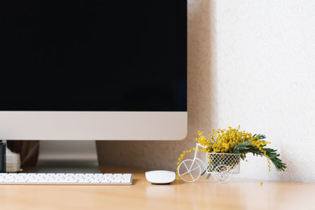 Concept of a business, freelancer, blogger. The laptop is on a wooden table against a white wall...
