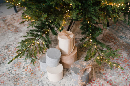 Gift boxes under a decorated Christmas treeの写真素材