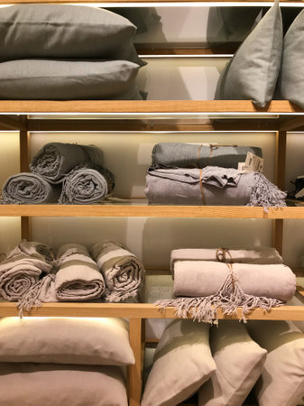 Linen or knitted plaids rolled up on a shop windowの写真素材