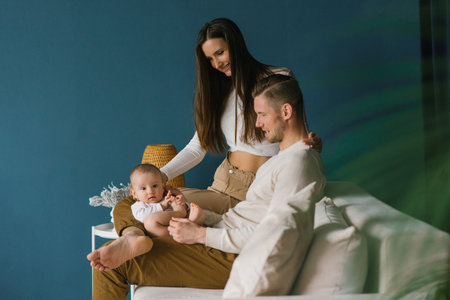 Happy positive family of the Caucasian race, a young father and mother, a little son are resting at...