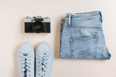 Accessories for urban travel. Jeans, sneakers, top view cameraの写真素材