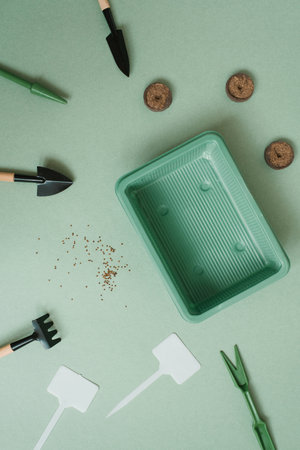 Set of garden equipment on a green background of the table at homeの写真素材