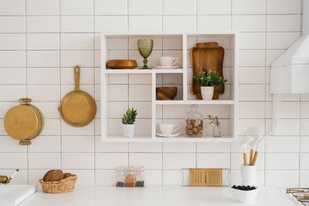 Modern new light wooden kitchen interior with white furniture and kitchen utensilsの写真素材