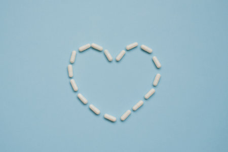 Heart made of various pills on a blue backgroundの写真素材