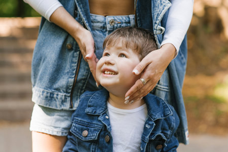 Mom caresses, hugs her little son on the faceの写真素材