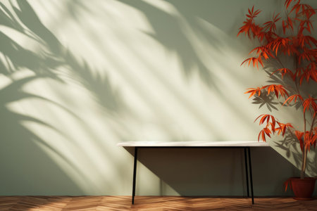 Minimalistic design in the living room. A wall with a table and a potted plant on the background of a green wall with shadowsの素材