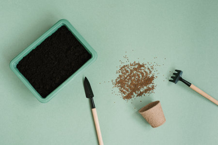 Accessories for garden tools, miniature flat surface on a green background, gardening concept, top view, indoor gardenの写真素材