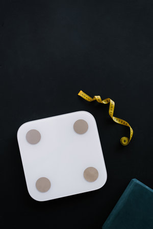 Flat lay weight scale and tape measure. Weight control conceptの写真素材