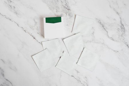 Disposable bags of cosmetics lie on a marble background with copy spaceの写真素材