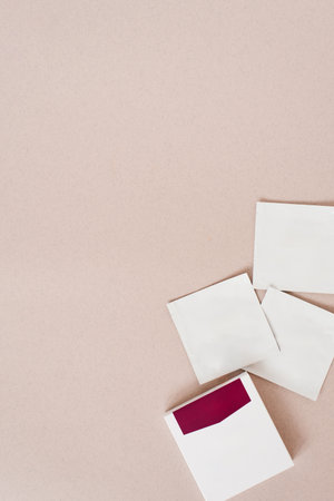 Disposable bags of cosmetics lie on a beige backgroundの写真素材