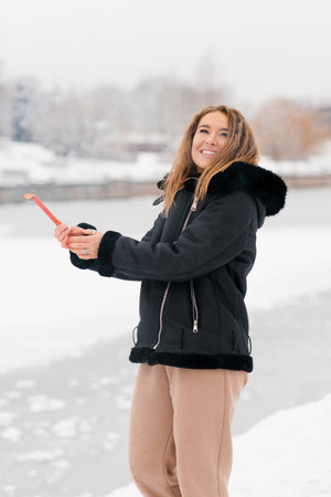 Young happy woman is smiling and holding a firework or sparkler in her handの写真素材