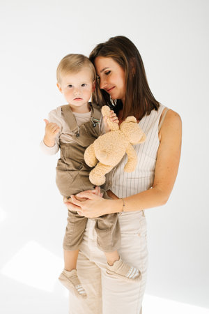 Young caucasian mother is holding little son. Concept of warmth and comfort, as the woman is holding her childの写真素材