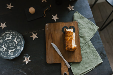 Loaf of bread on a wooden cutting board with a knife next to it