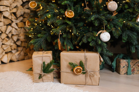 Christmas tree and two brown boxes with orange peels on them. Scene is festive and joyfulの写真素材