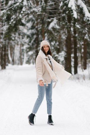 Young woman standing in the snow and smilingの写真素材