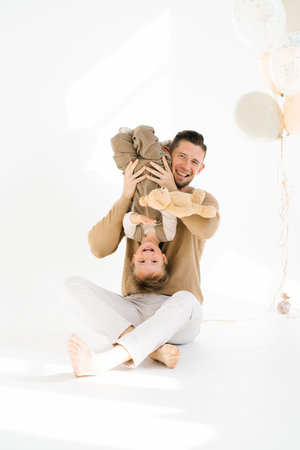 Young father and little son have fun together at a birthday partyの写真素材