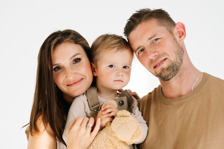 Caucasian young family with a young son in their armsの写真素材
