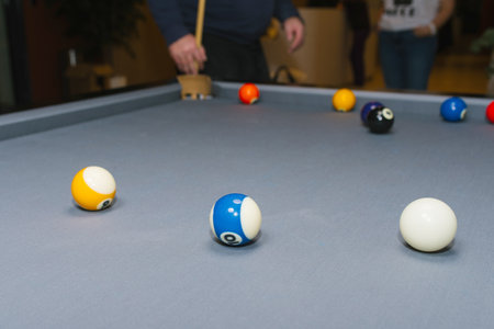 A closeup view of a billiard table featuring vibrant and colorful balls, emphasizing detail and...