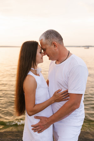 Man and woman are hugging on beach. Scene is romantic and intimateの写真素材