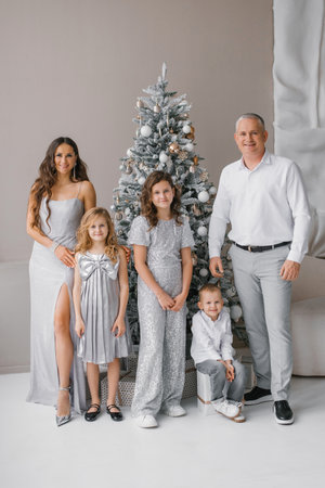 Happy young family with children at the Christmas treeの写真素材